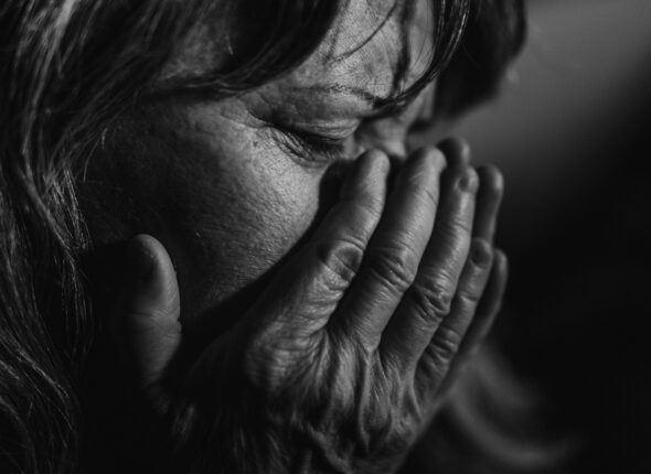 Close-up of unhappy elderly woman, black and white photo.